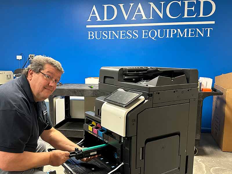 copier repait technician inserting drum into MFP copier