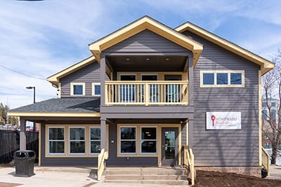 a bowl craftsman style building with yellow trim