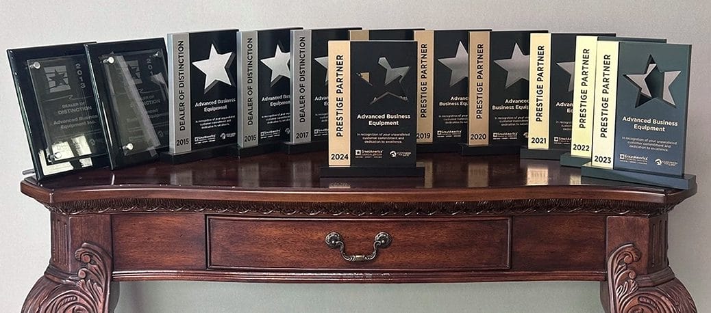 A row of awards from 2013 to 2024 lined up on a desktop